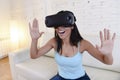 Happy woman at home living room sofa couch excited using 3d goggles watching 360 virtual reality