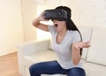 Happy woman at home living room sofa couch excited using 3d goggles watching 360 virtual reality