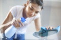 Happy woman house wife cleaning glass table in home