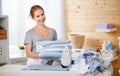 Happy woman housewife ironing clothes in laundry at home Royalty Free Stock Photo