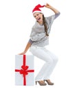 Happy woman in hristmas hat sitting on big christmas present box Royalty Free Stock Photo