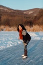 Happy woman ice skating on a frozen lake Royalty Free Stock Photo