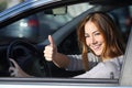 Happy woman inside a car gesturing thumb up Royalty Free Stock Photo