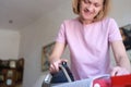 Happy woman ironing clothes with electric iron at home Royalty Free Stock Photo