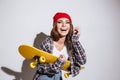 Happy woman isolated over white background holding skateboard Royalty Free Stock Photo