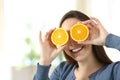 Woman joking with two half orange slices Royalty Free Stock Photo
