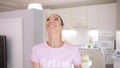 Happy woman juggle with apples on a kitchen at home