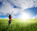 Happy woman jump in grass fields and blue sky Royalty Free Stock Photo