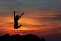 Happy woman jumping against beautiful sunset. Freedom, enjoyment