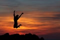 Happy woman jumping against beautiful sunset. Royalty Free Stock Photo