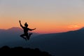 Happy woman jumping against beautiful sunset. Royalty Free Stock Photo
