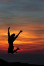 Happy woman jumping against beautiful sunset. Royalty Free Stock Photo