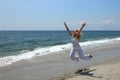 Happy woman jumping on a beach Royalty Free Stock Photo