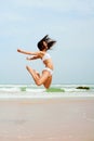 Happy woman jumping on the beach Royalty Free Stock Photo