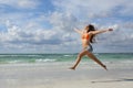 Happy woman jumping on the beach on holidays Royalty Free Stock Photo