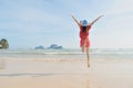 Happy woman jumping on the beach in Krabi Thailand