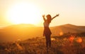 Happy woman jumping and enjoying life at sunset in mountains Royalty Free Stock Photo