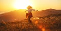 Happy woman jumping and enjoying life at sunset in mountains