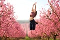 Happy woman jumping in a flowered field in spring Royalty Free Stock Photo