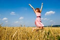 Happy woman jumping in golden field Royalty Free Stock Photo