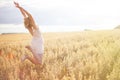 Happy woman jumping in golden wheat . Portrait of young girl Royalty Free Stock Photo