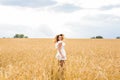 Happy woman jumping in golden wheat Royalty Free Stock Photo