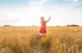 Happy woman jumping in golden wheat Royalty Free Stock Photo