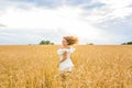 Happy woman jumping in golden wheat Royalty Free Stock Photo