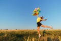 Happy woman jumping with multicolored balloons Royalty Free Stock Photo