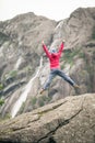 Happy woman jumping on rock in mountains Royalty Free Stock Photo