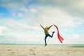 Happy woman jumping with scarf on beach Royalty Free Stock Photo