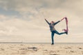 Happy woman jumping with scarf on beach Royalty Free Stock Photo