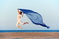 Happy woman jumping on sea beach Royalty Free Stock Photo