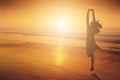 Happy Woman Jumping in Sea beach Sunset silhouette. Royalty Free Stock Photo