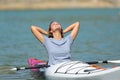 Woman in a kayak relaxing in a lake