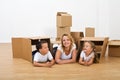 Happy woman and kids relaxing in their new home Royalty Free Stock Photo