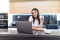 Happy woman in the kitchen reading he news on her laptop at home Royalty Free Stock Photo