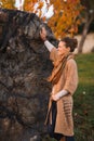 Happy woman in knitted cardigan enjoying evening in autumn park Royalty Free Stock Photo