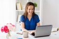 Happy woman with laptop working at home or office