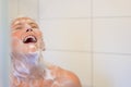 Happy woman laughing as she enjoys a shower