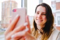 Happy woman laughing having online video call with friends or family smartphone