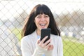 Happy woman laughing holding phone looking at you Royalty Free Stock Photo