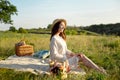 Happy Woman Life Style, beautiful relaxed girl in a straw hat on the nature picnic basket flowers in the rays of the