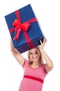 Happy woman lifting big present Royalty Free Stock Photo