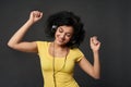 Happy woman listening music in headphones and dancing with closed eyes Royalty Free Stock Photo