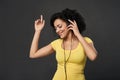 Happy woman listening music in headphones and dancing with closed eyes Royalty Free Stock Photo