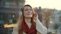 Happy woman listening music headphones on street. Lady walking in earphones. Royalty Free Stock Photo