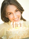 Happy Woman With Lit Candles On Cake Royalty Free Stock Photo