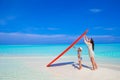 Happy woman and little girl at white beach with