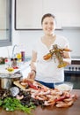 Happy woman with lobster in home kitchen Royalty Free Stock Photo